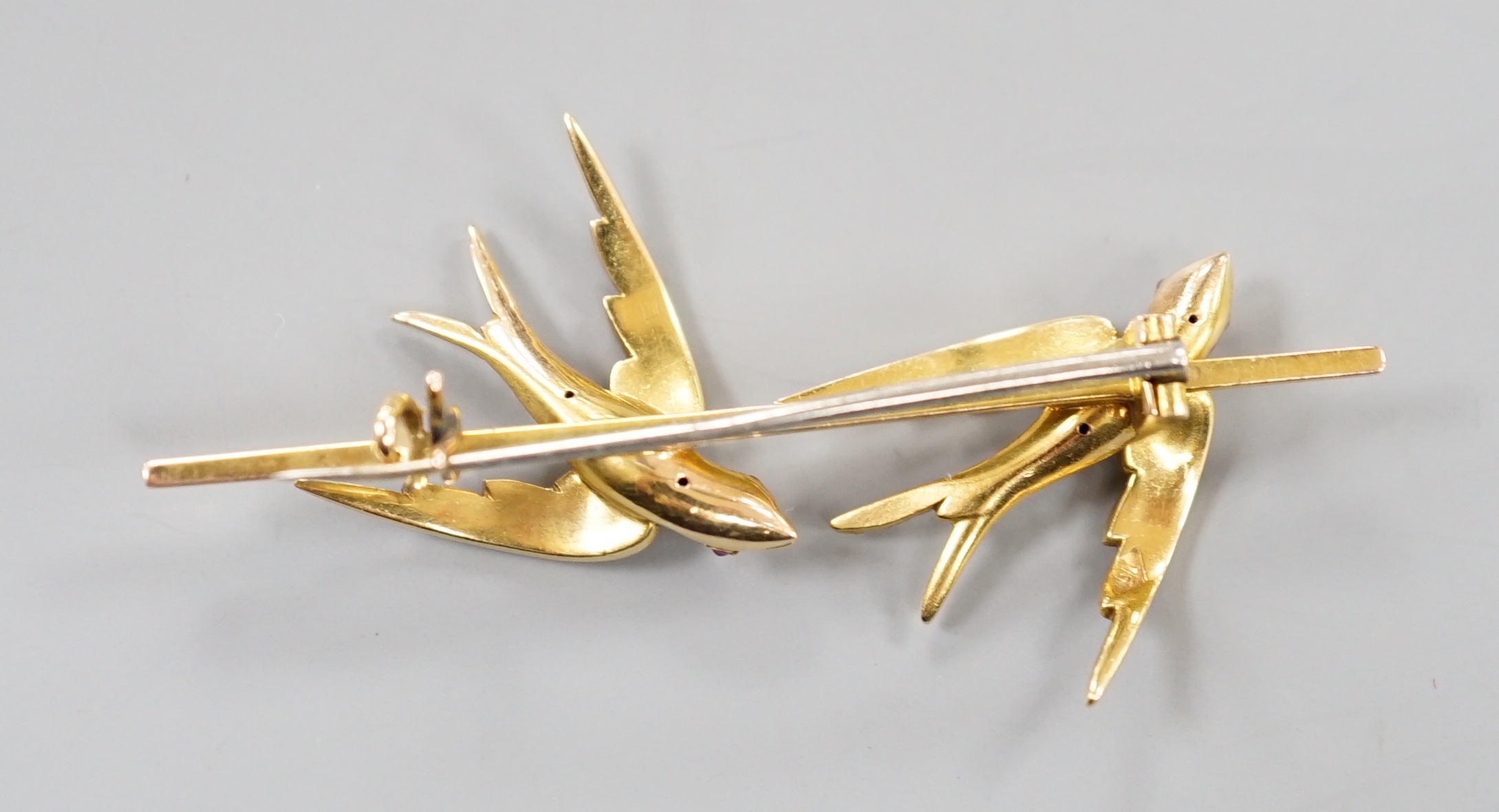 An Edwardian yellow metal and seed pearl set twin swallow bar brooch, 54mm, gross weight 6.5 grams.